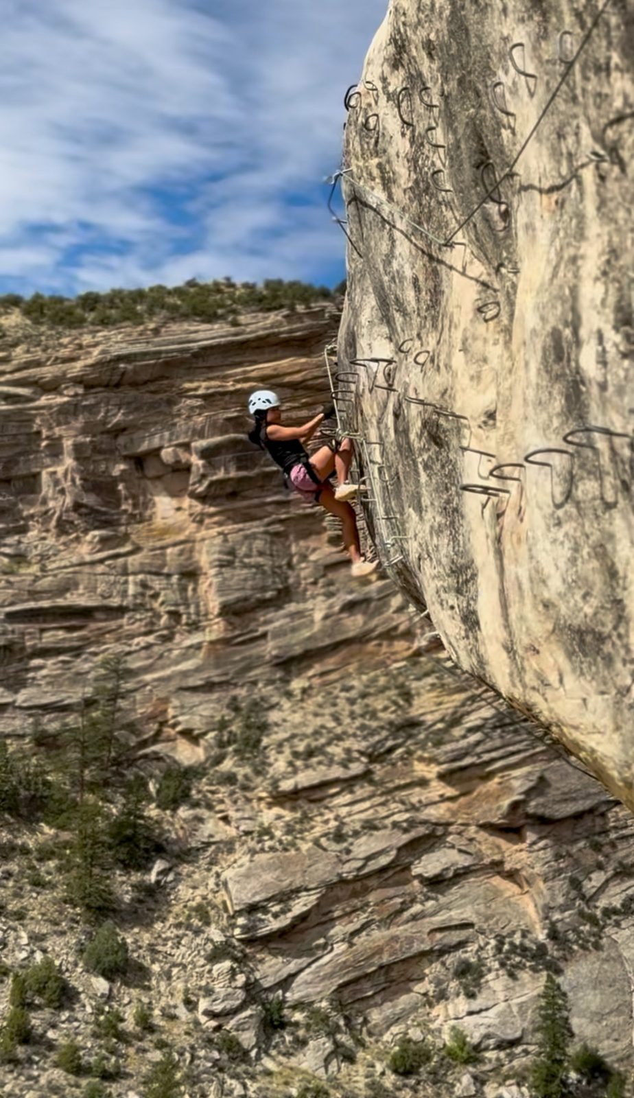 A climber clipped in on the Ashley Gorge via ferrata